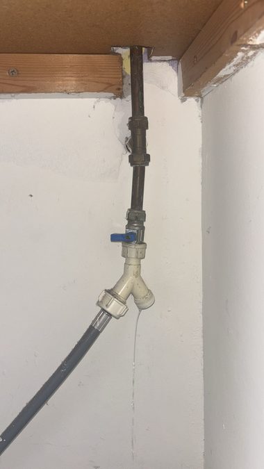 Washing machine valve dripping under a cupboard